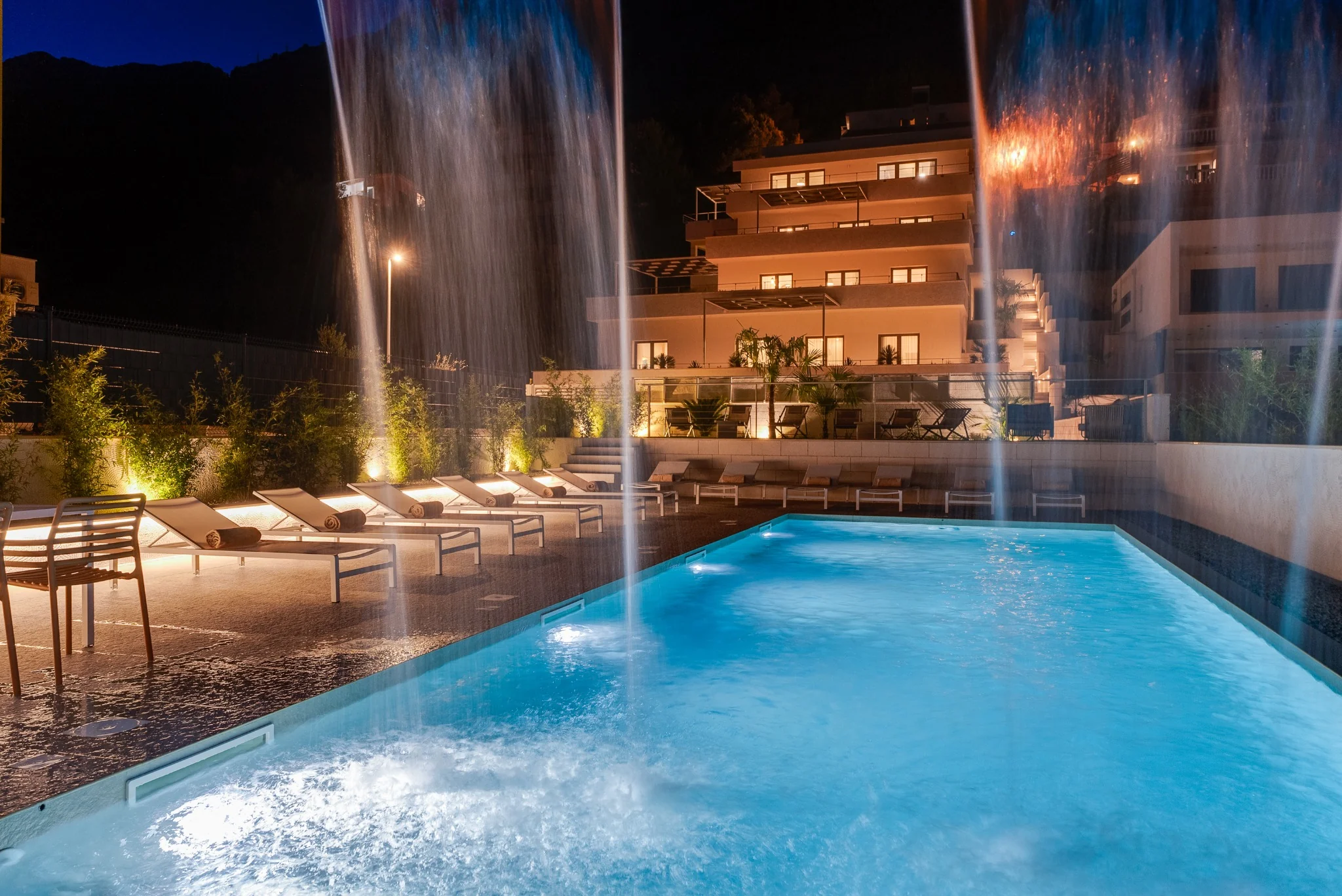 Private outdoor pool illuminated at night